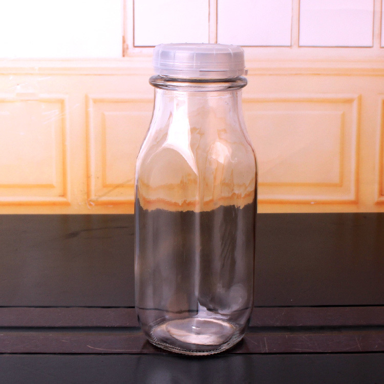 OEM/ODM 180ml Glass Milk Bottle with Lid